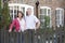 Farmer And Wife Standing In Front Of Farmhouse