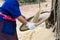 Farmer winnowing rice.