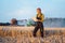 Farmer woman with clipboard on field, harvest going on