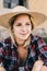 Farmer woman enjoys life outdoor. 30 years old woman sitting outdoor at barn door.