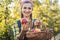 Farmer woman in fruit orchard holding apple in her hands