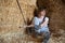 Farmer woman resting on haystack on her work break