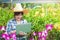 A farmer woman standing on a laptop delivering information