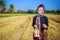 Farmer woman with tiffin carrier in rice field