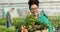 Farmer, woman and vegetables basket in greenhouse, agriculture and sustainability with farming portrait. Young african