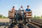 Farmer workers on a tractor plant potato seeds. Automation of process of planting potatoes seeds. High efficiency and speed.