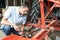 Farmer Working On Agricultural Equipment In Barn