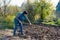 Farmer working in a garden. dig up the ground. Plant a crop. Sowing work. Spring work in the garden. Working with a rake. suburban