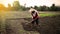 A farmer is working on land with hoe to be planted with rice entering the rainy season in so