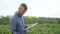 Farmer writes down the growth rates of soybeans. Concept ecology, bio product, inspection, natural products