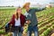 Farmer young man and woman communicate in the field