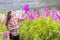 Farmers are admiring flower garden production. Happy young Woman walking in the orchid plant. People work at the orchid farm