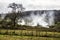 Farmers burn wild bushes in a foggy morning