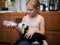 Farmers daughter feeds newborn lamb from a bottle