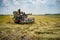 Farmers driving Harvester car during harvesting rice season at rice field farm in Thailand with clear sky and golden rice