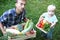 Farmers family. Father keeps a big box of vegetables, and his to