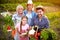 Farmers family holding vegetables from garden