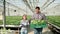 Farmers in greenhouse with modern technology for growing vegetables