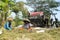 Farmers are grinding rice with a mobile rice milling machine.