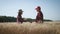 Farmers handshake over the wheat crop in harvest time. Team farmers stand in a wheat field with tablet. Partnership