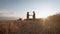 Farmers handshake over the wheat crop in harvest time. Team farmers stand in a wheat field with tablet at sunset