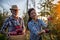 Farmers harvesting apples in orchard