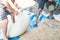 Farmers putting wheat grains in sack