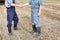 Farmers shaking hands against harvester in field