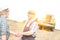 Farmers shaking hands while standing on field at farm