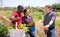 Farmers talk during meeting on field after harvesting vegetables