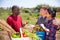 Farmers talk during meeting on field after harvesting vegetables