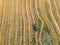 Farmers works in field. Tractor cultivating field at spring. Aerial view.