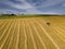 Farmers works in field. Tractor cultivating field at spring. Aerial view.