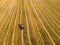 Farmers works in field. Tractor cultivating field at spring. Aerial view.