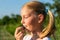 Farmers young daughter harvests blueberries from a bush and enjoy taste of berry