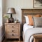 Farmhouse interior design of modern bedroom. Vintage wooden bedside cabinet near wooden bed