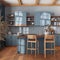 Farmhouse vintage wooden kitchen in blue and beige tones with island and stools. Parquet floor, shelves and cabinets. Colonial