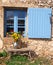 Farmhouse window with blue shutter