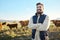 Farming, confidence and cows and portrait of man with smile on field, happy farm in countryside with dairy and beef