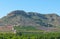 Farming fields at the base of hills and small mountains local community growing fields. Agriculture in rural Spain.