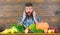 Farming and harvesting concept. Man bearded look at harvest wooden background. Farmer with homegrown crops on table