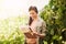 Farming involves more admin than youd think. a happy young farmer examining the crops on her farm.