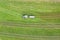 Farming machine spraying cow dung on a field from above