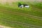 Farming machine spraying cow dung on a field from above