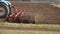 Farming: plowing. Tractor in a field followed by flying birds