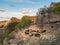 Farming sheep, mountain animal husbandry. A flock of sheep graze high in the mountains in the background of the village. Dagestan