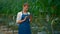 Farming specialists controlling tomato production using digital tablet in farm.