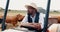 Farming, tractor and black man in cattle field, sustainability and agriculture in countryside. Nature, animals and cow