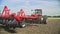 Farming tractor plowing field. Farming machinery. Agricultural machinery working