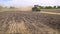 Farming tractor working on arable field. Agricultural tractor plowing land